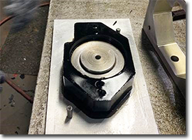 small black polyurethane part in mold